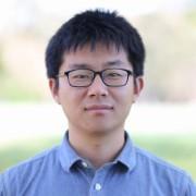 Headshot of TLP 2026 participant Chenchen Zhao. Chenchen has short, thick black hair, almond shaped brown eyes and fair skin. He is wearing black rectangular framed glasses and a blue business shirt