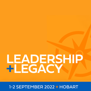 Leadership + Legacy Symposium hero tile. An orange rectangle takes up the main area of the image. In front of the orange is one section of text in white "Leadership + Legacy" in all caps. On the right hand side is a darker orange compass graphic sitting behind the text. On the bottom of the tile is a blue rectangle with text in white "1-2 September 2022 + Hobart" in smaller all caps